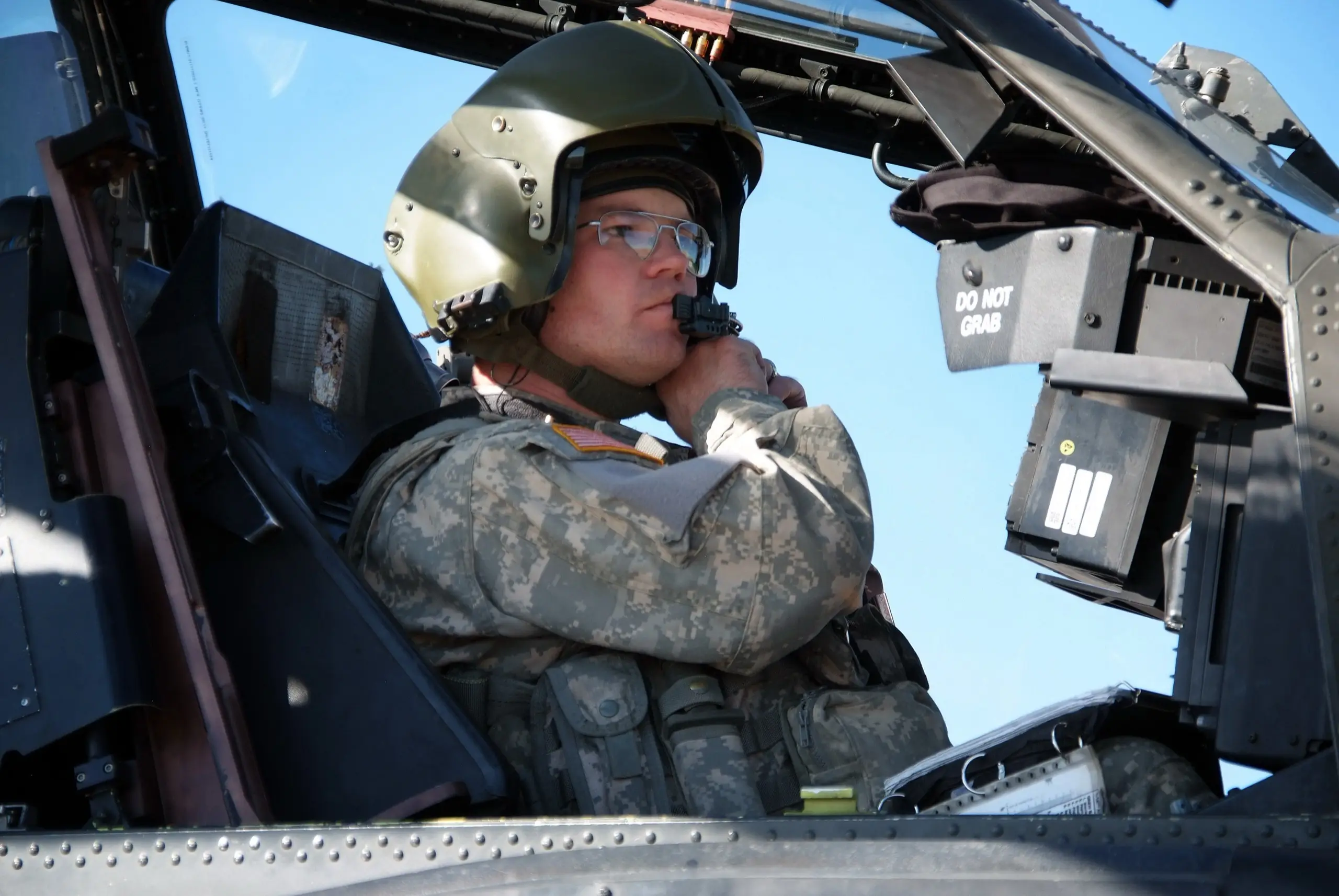 Apache copilot/gunner in the front cockpit adjusting his helmet-mounted display sight