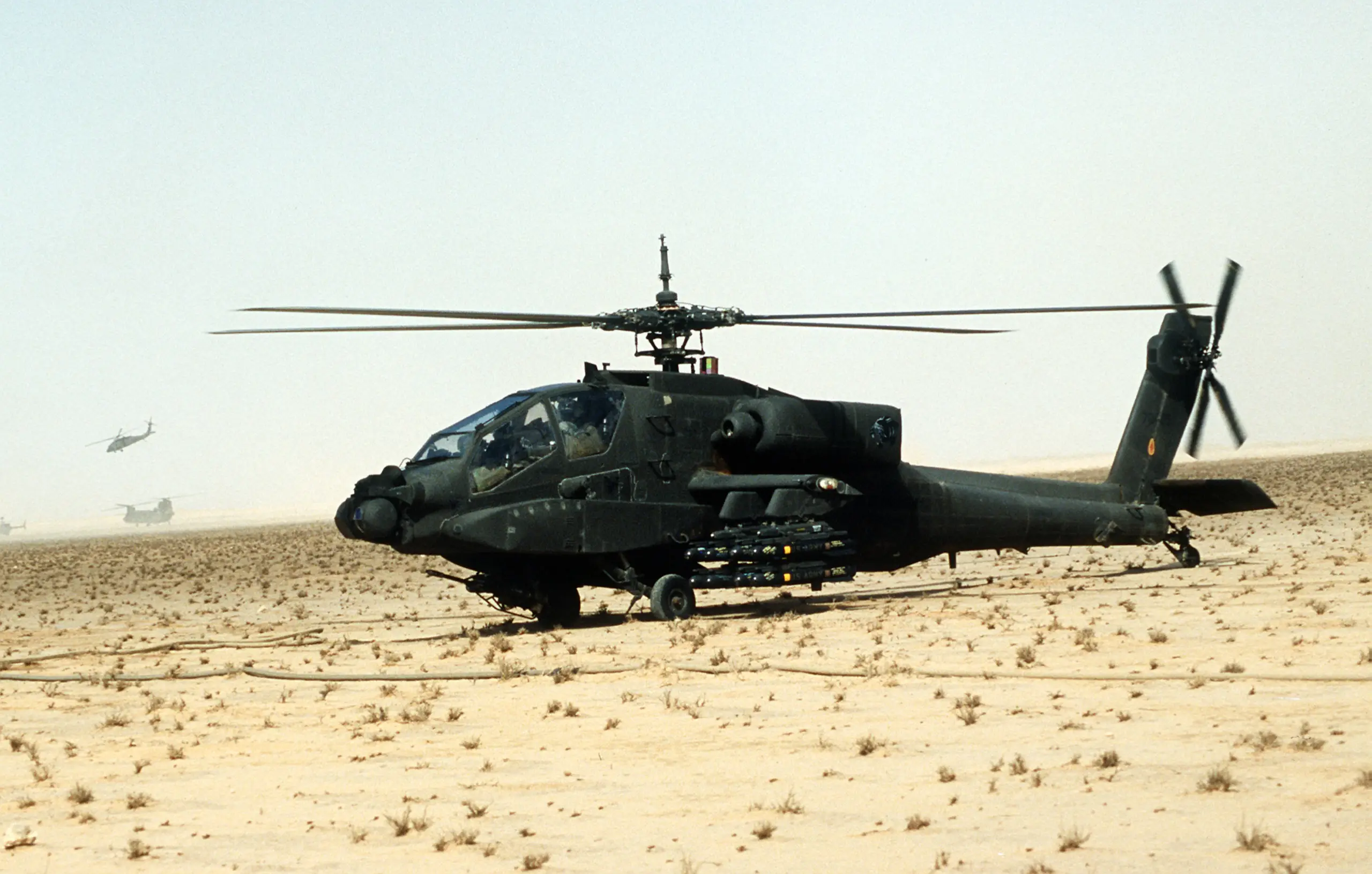 AH-64A Apache armed with Hellfire missiles waiting on the desert sand during Operation Desert Storm