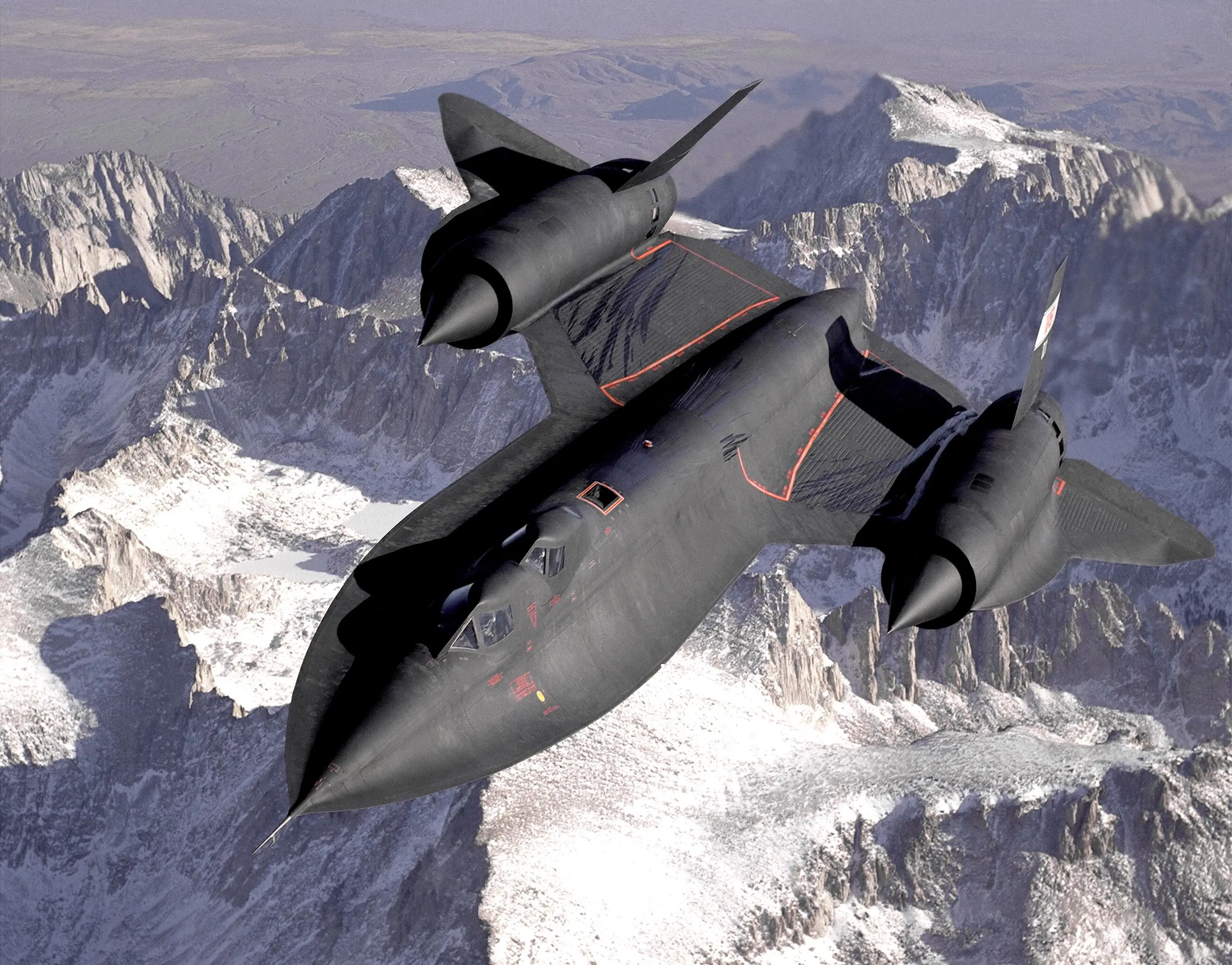 SR-71B Blackbird in flight over the snow-covered Sierra Nevada mountains
